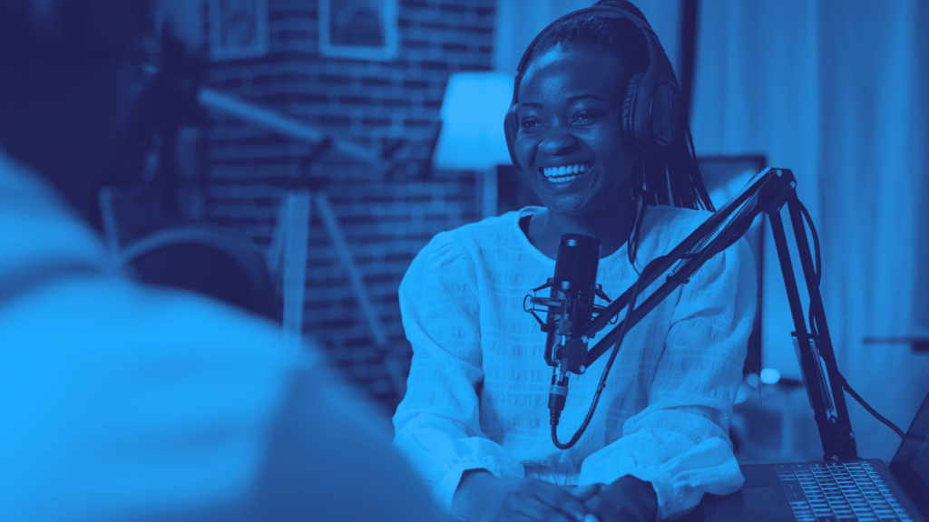 An influencer talks on a podcast, speaking into a microphone. 